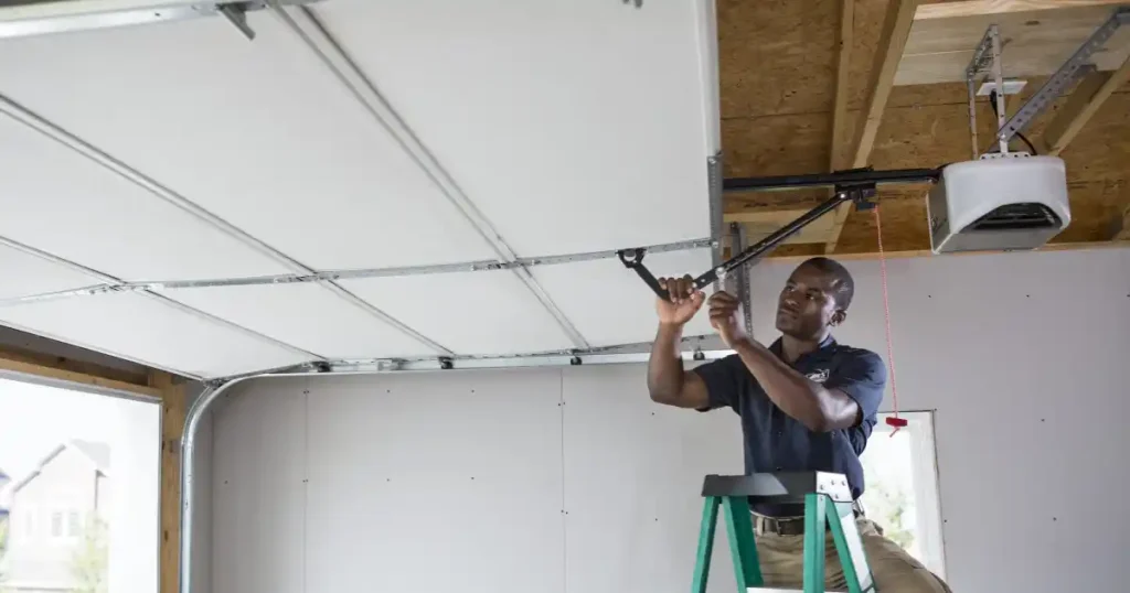 person working on a garage door